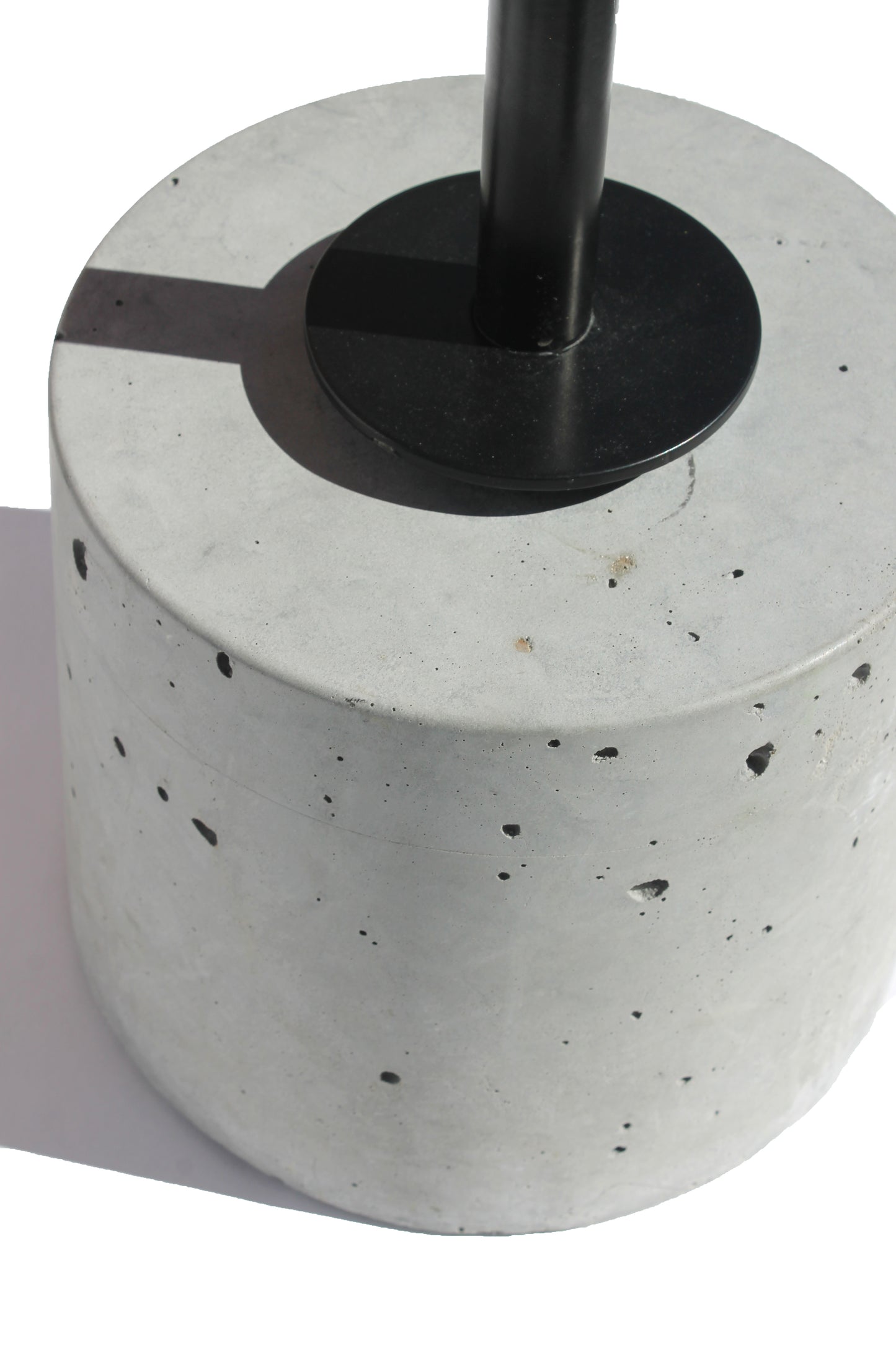 Close-up of the concrete base and steel support on the Cantilever Side Table