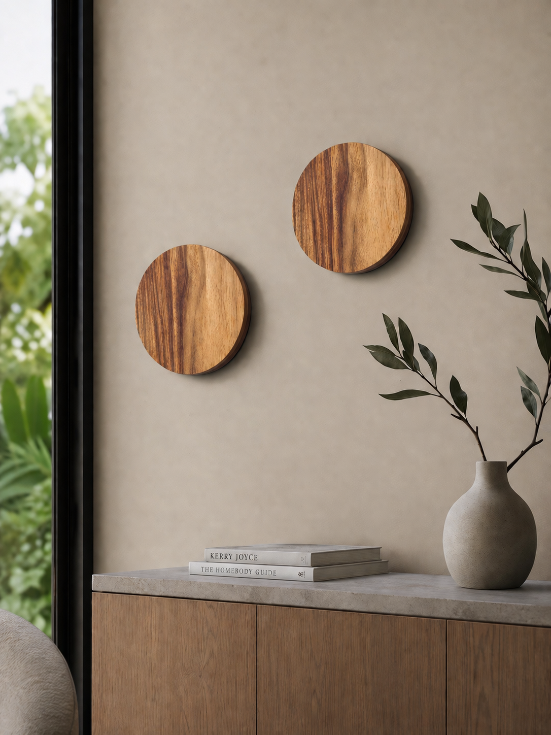 Two Namibian Teak Circle Wall Lights installed beside a window