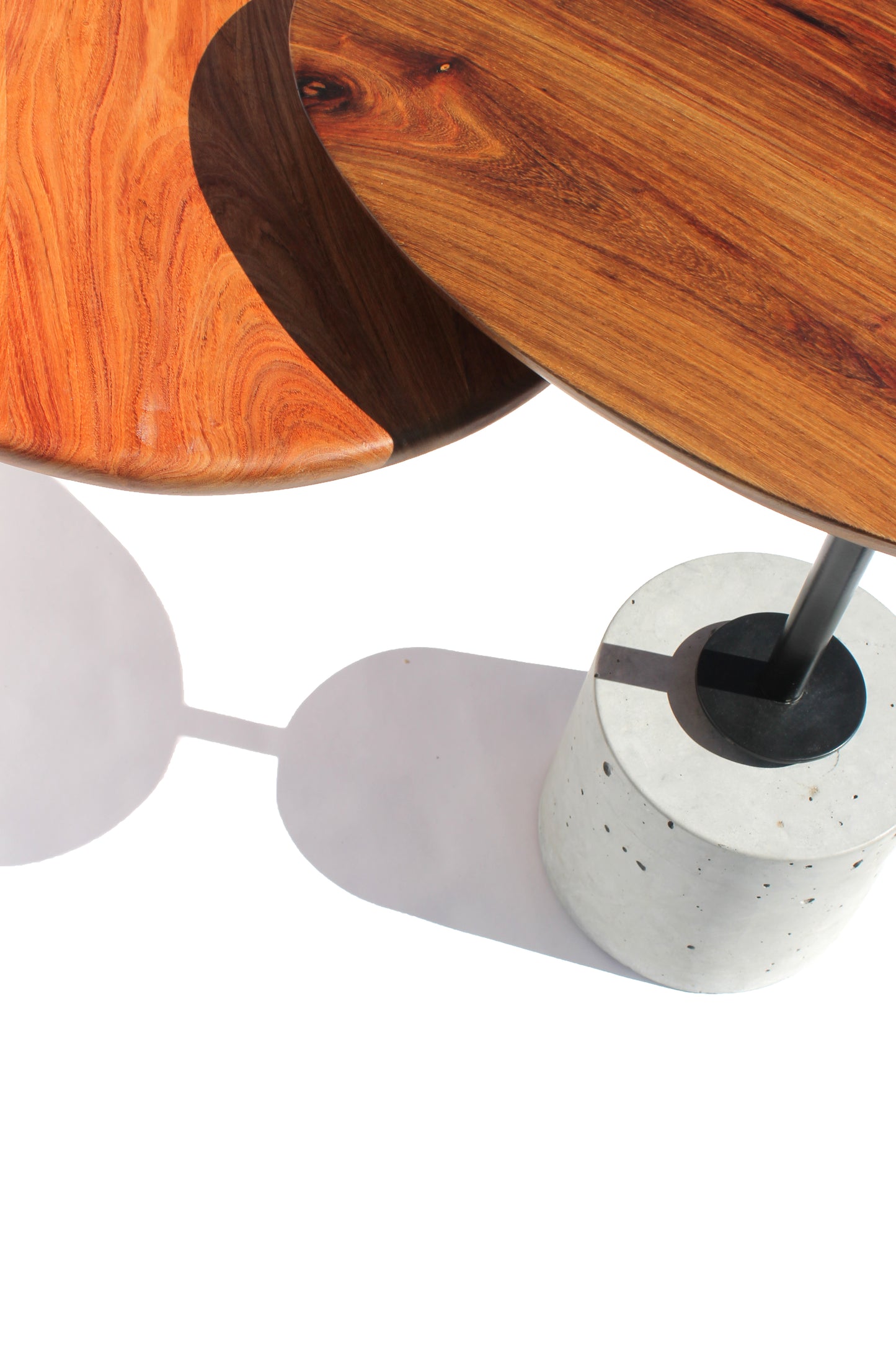 Close-up detail of the Cantilever Nesting Tables showing the timber, steel and concrete connection