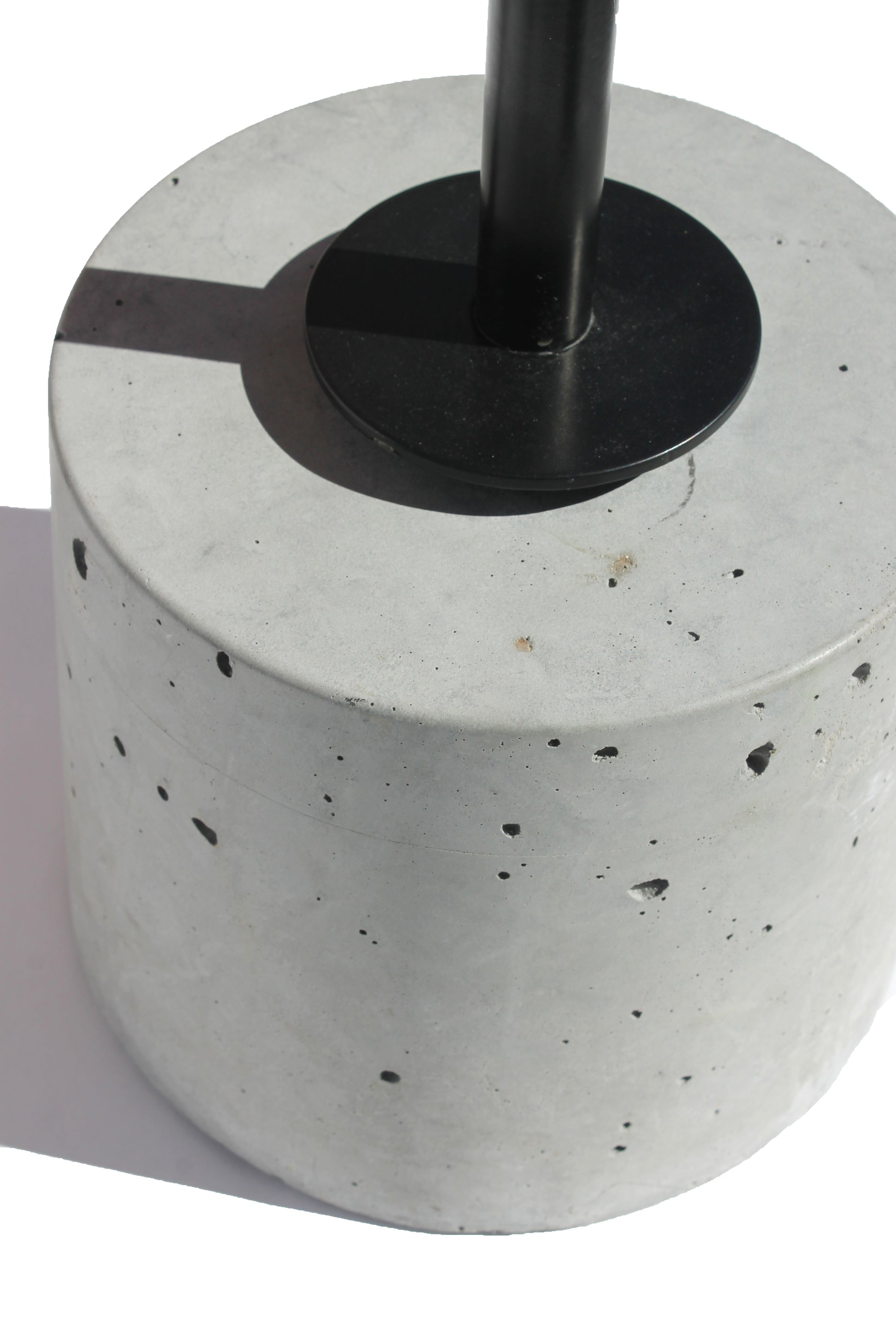 Close-up of the concrete base and steel support on the Cantilever Side Table