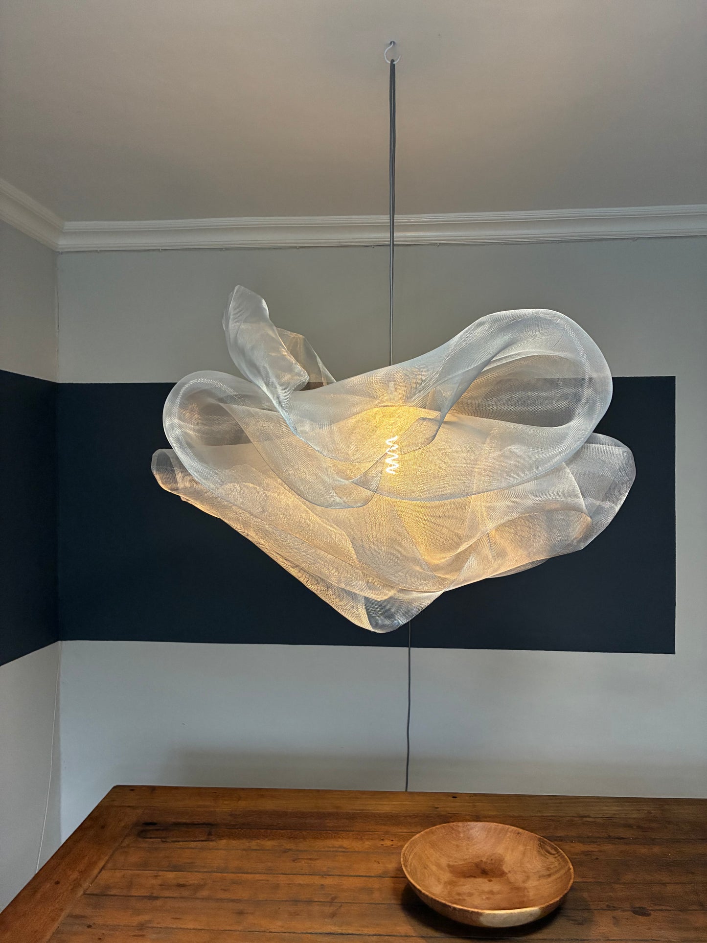 Industrial Mesh Pendant installed above a dining table in a modern home