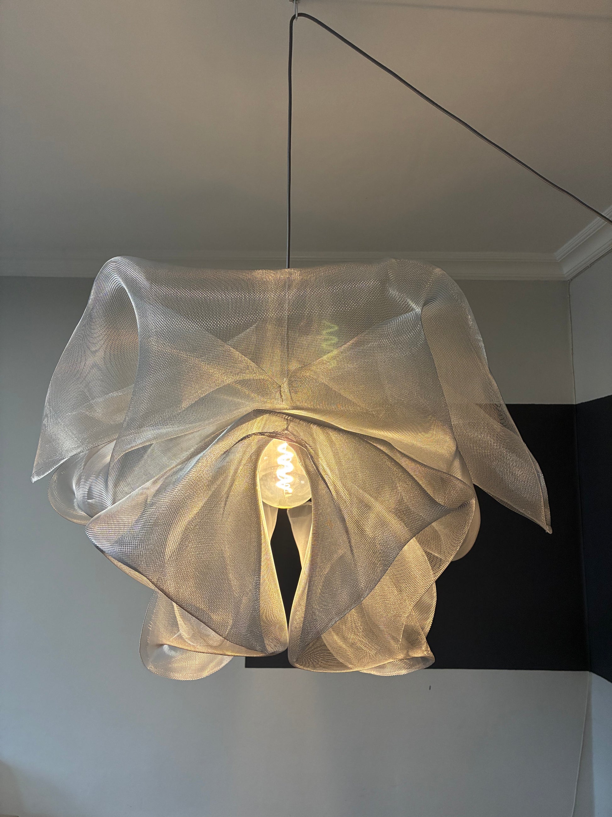 Front view of the Industrial Mesh Pendant above a dining table