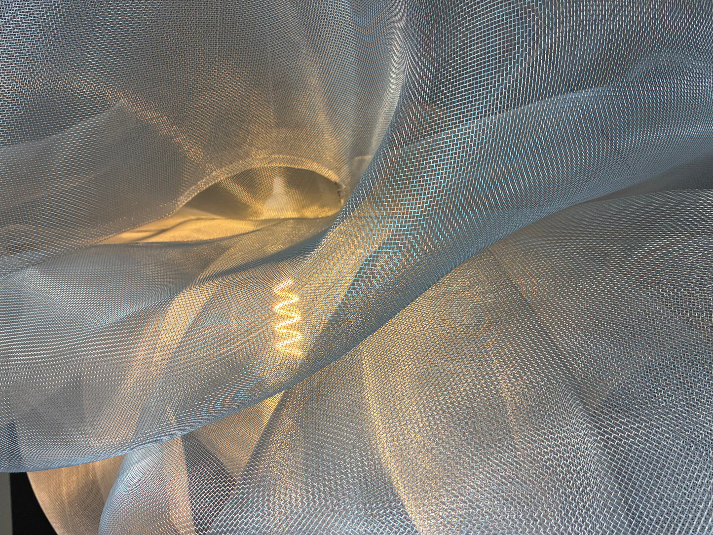 Close-up of the illuminated Industrial Mesh Pendant showing the mesh texture