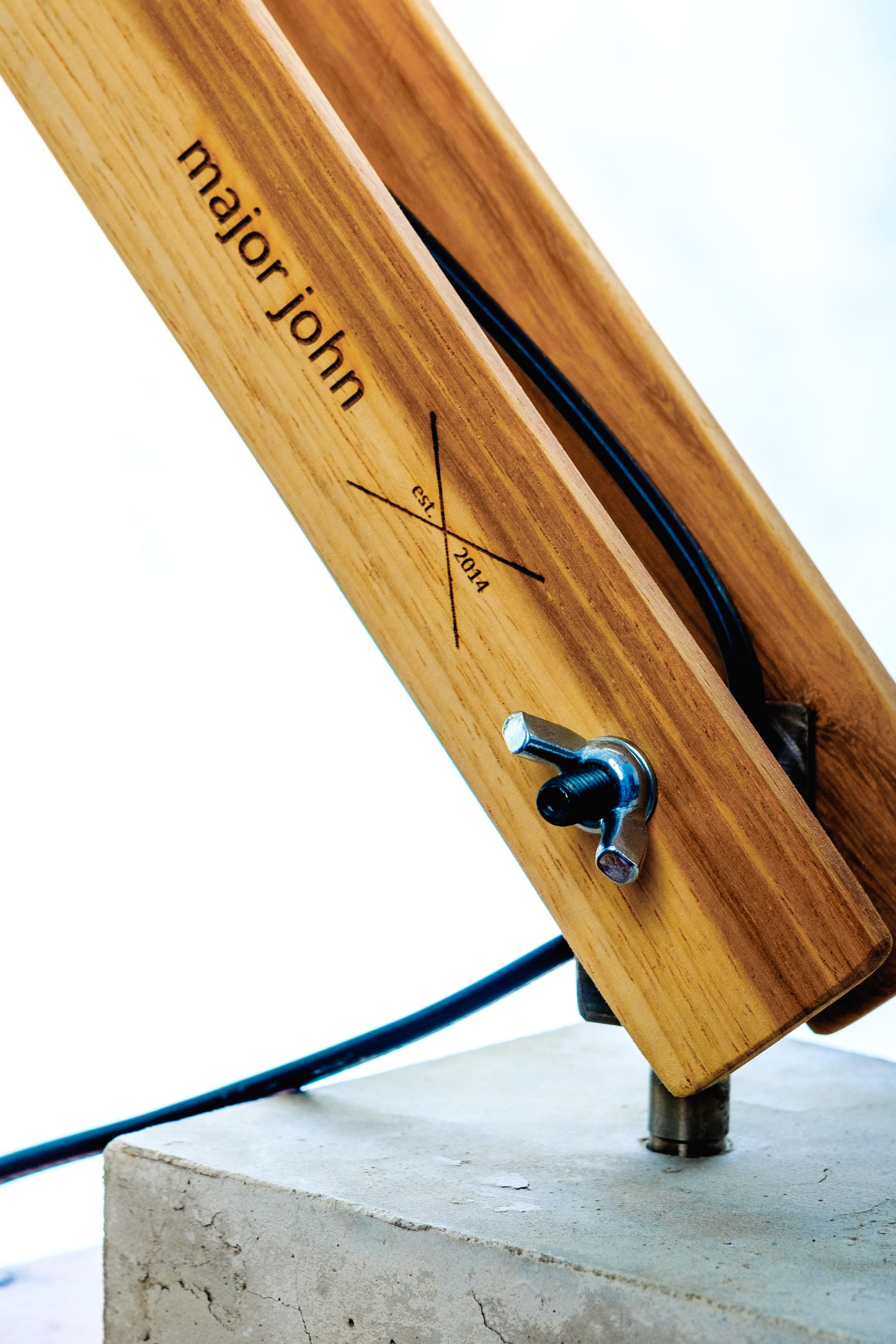 Close-up of the concrete base and timber detail on the Namibian Teak Desk Lamp