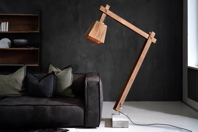 Namibian Teak Timber and Concrete Floor Lamp in a living room with the lamp in a lower position