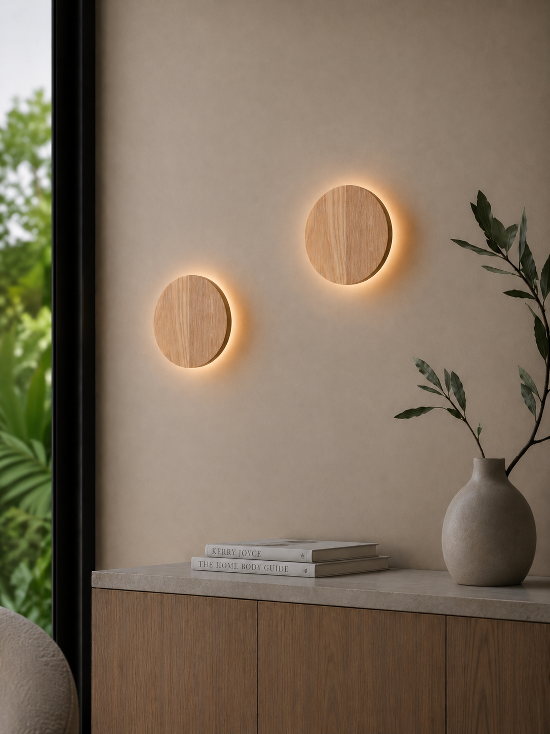 Two illuminated Oak Circle Wall Lights installed beside a window