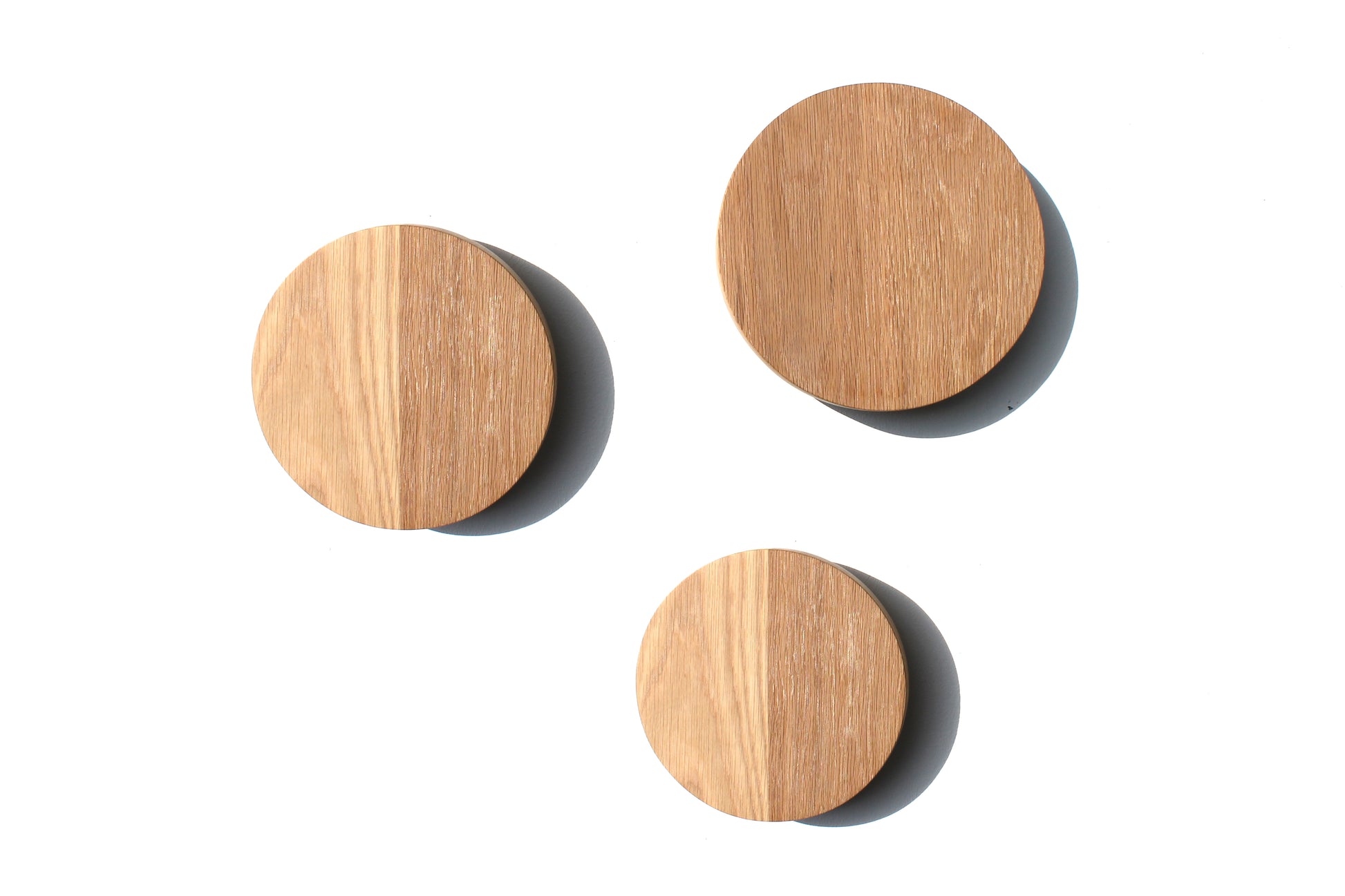 Three handcrafted Oak Circle Wall Lights on a white background