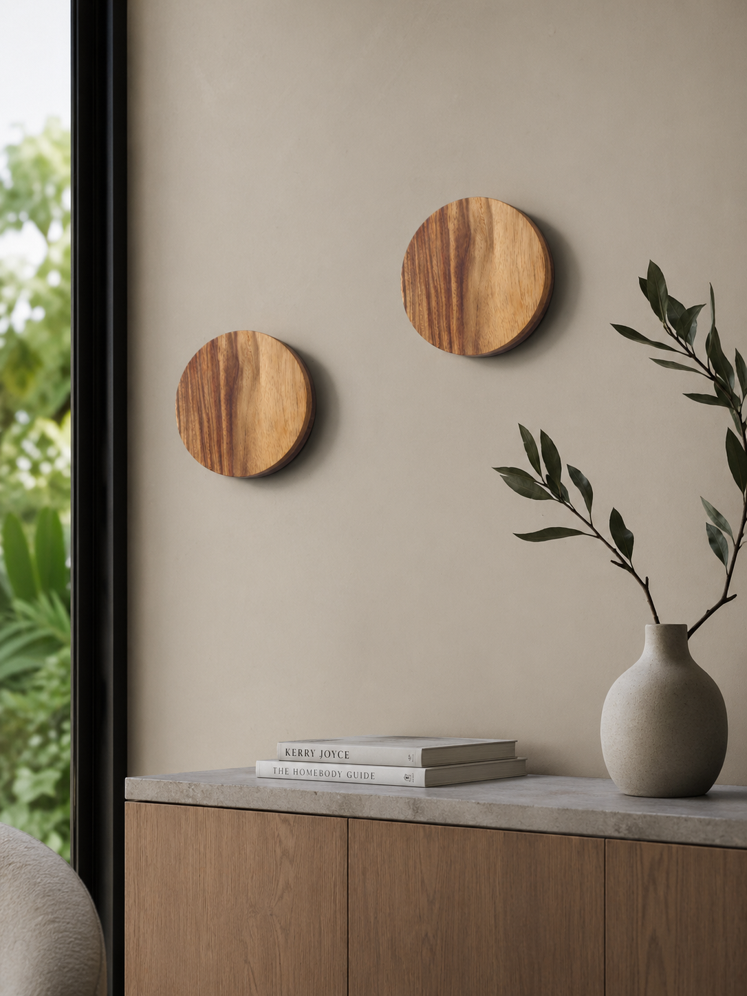 Two Namibian Teak Circle Wall Lights installed beside a window