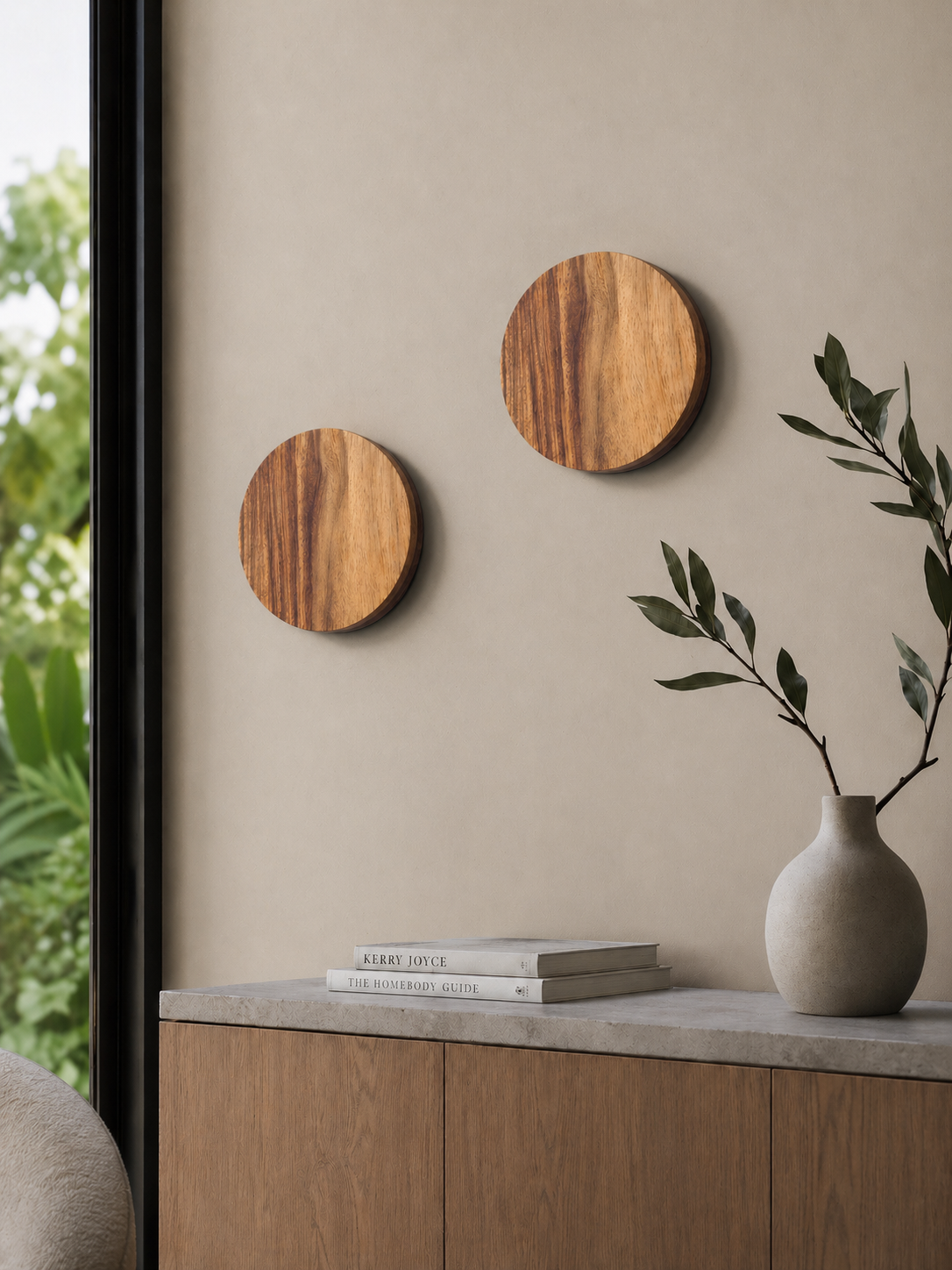 Two Namibian Teak Circle Wall Lights installed beside a window