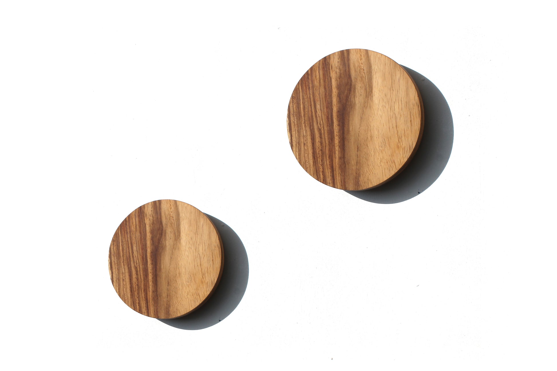 Two Namibian Teak Circle Wall Lights on a white background